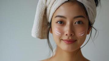 beautiful young aisan woman with towel on her head photo