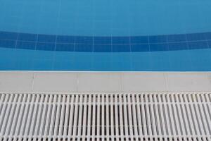 Swimming pool with clear water on a bright sunny day while on vacation and travel. photo