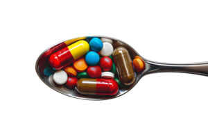 A spoonful of colorful tablets against a transparent background, top view png