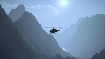 A helicopter is flying over a mountain range video