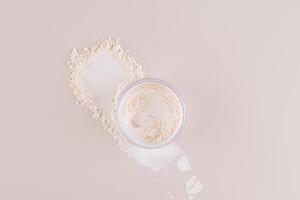 The jar of loose powder in the jar sits on the powder swatch next to the makeup pad. Top view. Delicate matte powder. Easy blending. photo