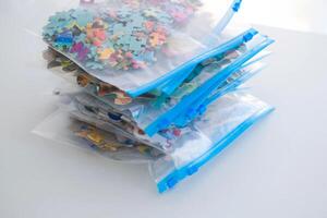 Organization of space and storage of children's board games. Storing puzzles in zip bags. photo