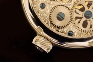A part of a transparent watch with visible gears photo