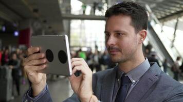 Portrait of Young Successful Man Using Tablet Screen on Business Travel Trip video