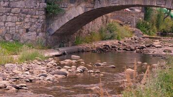 Stone bridge crossing small river video