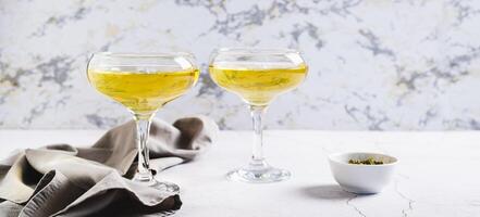 Trendy matcha martini cocktail in glasses on the table web banner photo