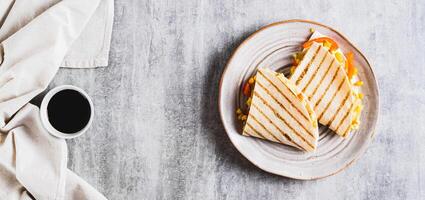 Chicken quesadilla with corn and peppers wrapped in tortilla on a plate top view web banner photo