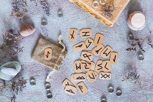 Scandinavian runes for fortune telling made of cardboard on the table next to the bag top view photo