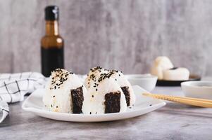 Onigiri traditional Japanese food of rice and tuna on a plate on the table photo