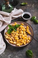 Navy pasta with ground meat in a plate on the table vertical view photo