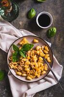 Navy pasta with ground meat in a plate on the table top and vertical view photo