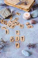 Fortune telling from four Scandinavian runes on a table in mystical decor vertical view photo