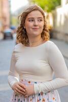 Happy redhead woman smiling looking away dreaming resting good news feel satisfied in city street photo