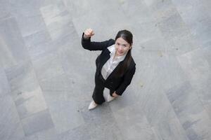 Confident businesswoman giving thumbs down photo