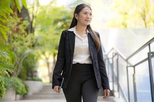 Confident businesswoman walking downstairs outdoors photo