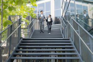 Business colleagues conversing on staircase photo