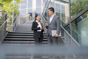 Business colleagues discussing work outdoors photo