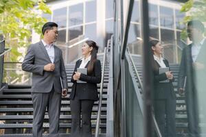 Business colleagues discussing work outdoors photo