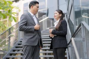 Business colleagues discussing work outdoors photo