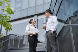 Business colleagues discussing work outdoors photo