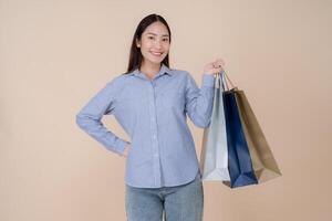 Joyful young woman holding shopping bags photo