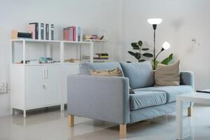 Modern living room interior with comfortable sofa and bookshelf photo