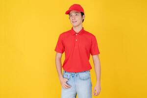 Confident delivery man standing on yellow background photo