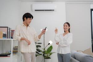 Couple enjoying air conditioning at home photo