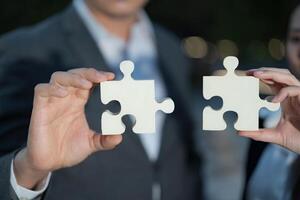 Business partnership concept with connecting puzzle pieces photo