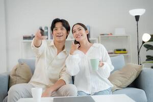 Happy couple enjoying television time together at home photo