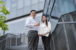 Business colleagues discussing work outdoors photo