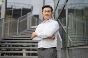 Confident businessman descending outdoor stairs photo