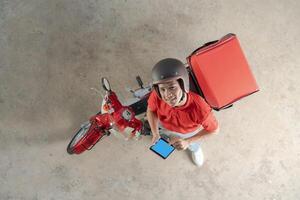 Delivery rider with red motorcycle ready for service photo