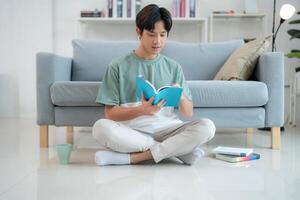 Young man enjoying a book in a modern living room photo
