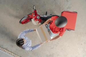 Delivery service handoff, motorbike courier giving package to customer photo