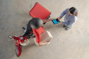Delivery man handing over package to customer photo