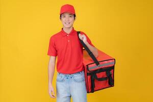 Cheerful delivery man holding insulated food bag photo