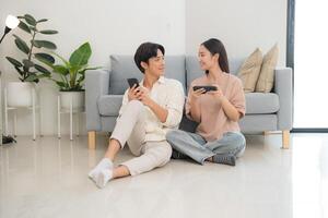 Young couple enjoying smartphone entertainment at home photo