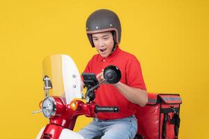 Smiling delivery man on a motorcycle photo