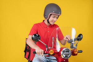 Smiling delivery man on a motorcycle photo