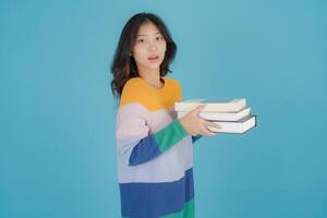 Woman in a striped sweater holding a stack of books photo