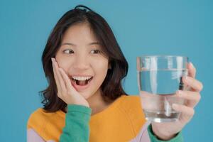 Cheerful woman holding a glass of water photo