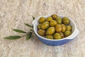Tasty marinated olives in the bowl photo