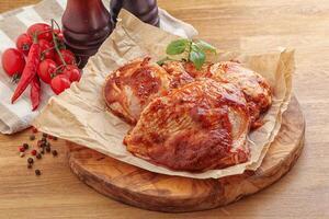 Marinated chicken leg in tomato sauce photo