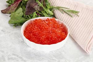 Red caviar in the bowl photo