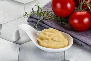 Dijon mustard sauce in the bowl photo