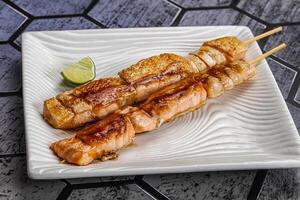 Grilled salmon skewer with sauce photo