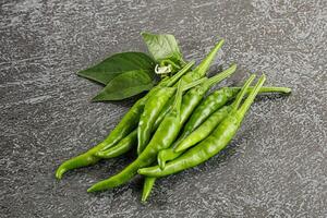 Spicy green chili pepper heap photo