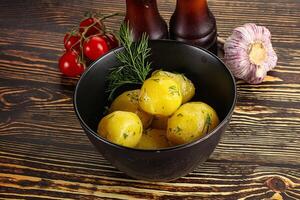 Boiled potato with oil and dill photo