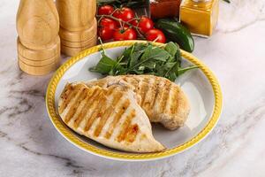 Grilled chicken breast served arugula photo